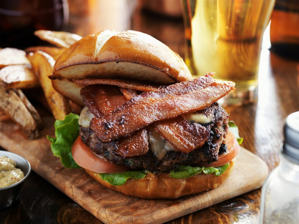 bacon burger with pretzel bun and beer