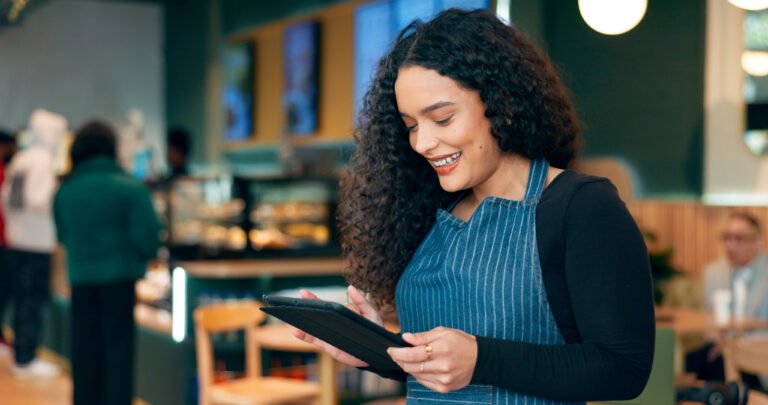 Gestora de restaurante usando tablet para acompanhar reservas e fluxo do salão